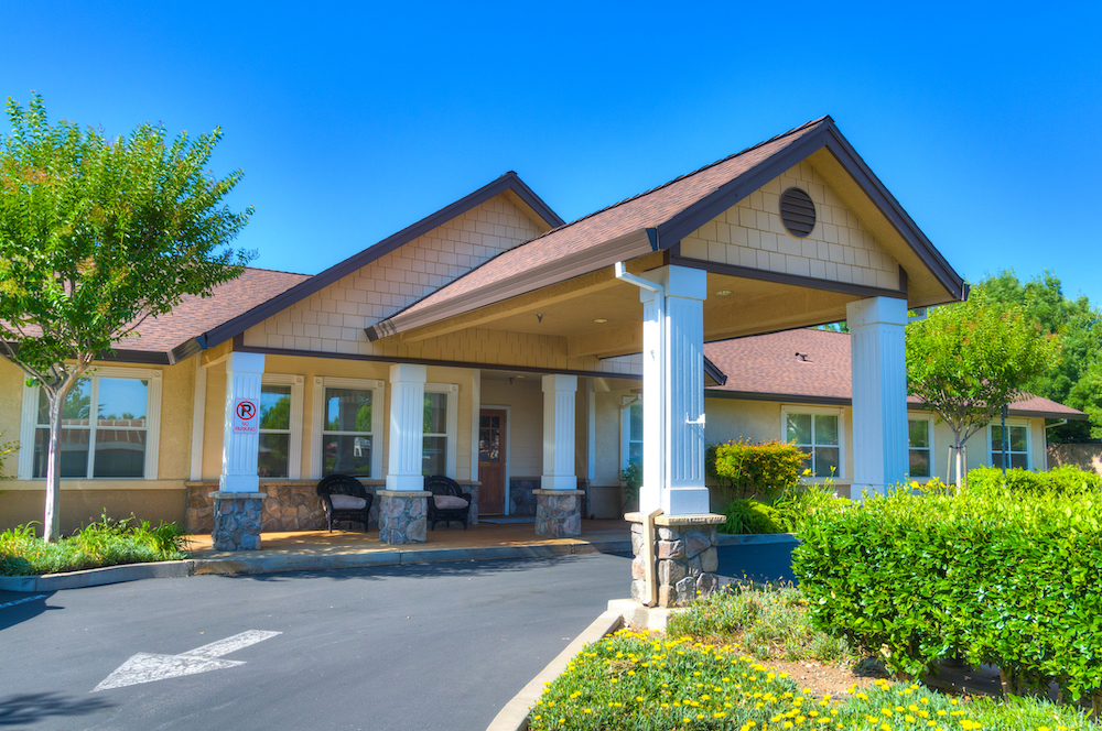Covered entry at The Meadows with white columns and landscaping